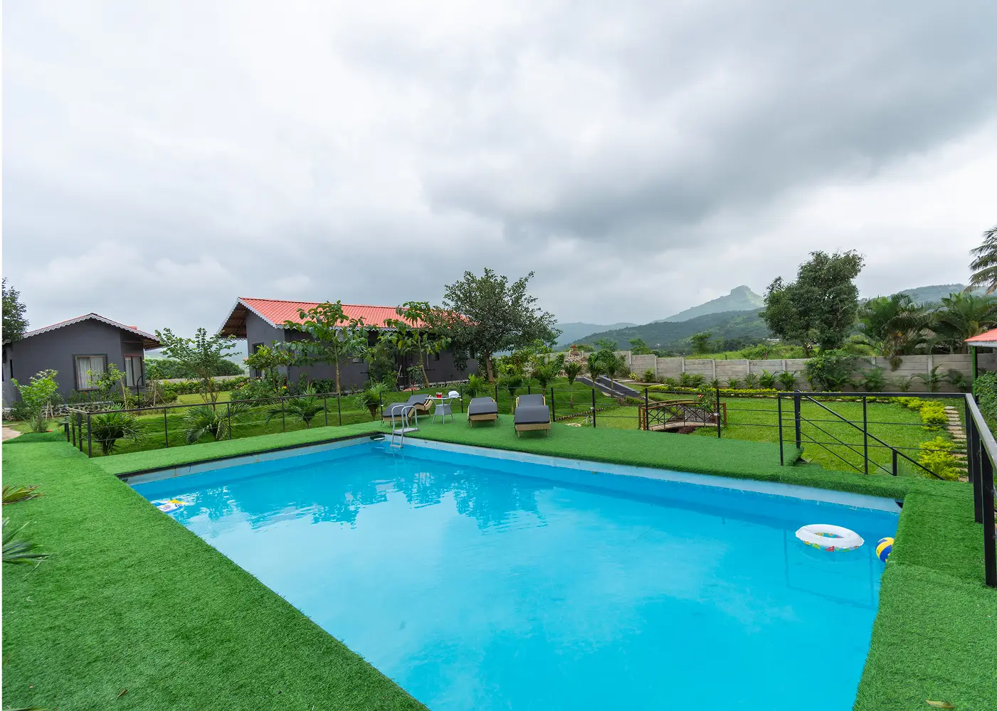 Serene surroundings and swimming pool at Varuwoods resort