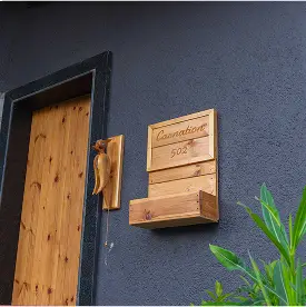 Carnation cottage surrounded by lush greenery at Varuwoods